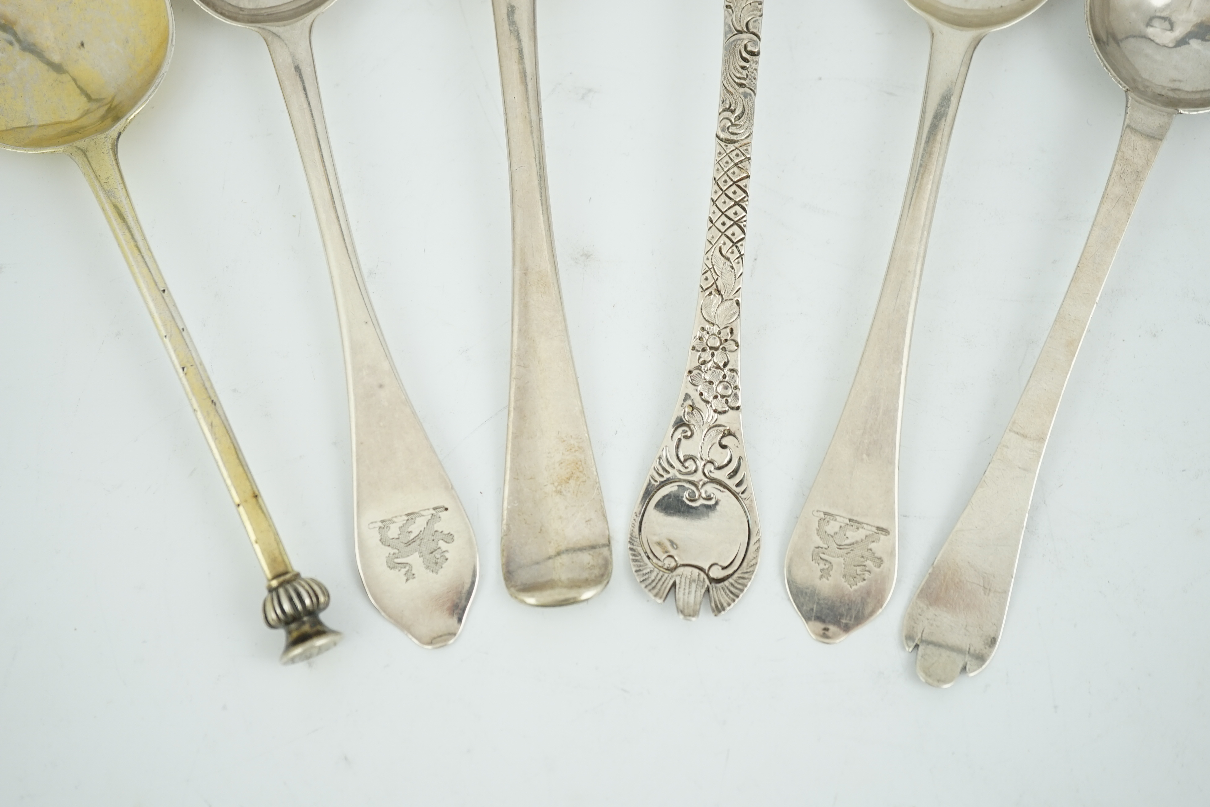 A George I provincial Brittania standard silver trefid spoon, later decorated as a berry spoon, Edmond Richard, Exeter, 1713, 21cm, together with five other 18th century spoons